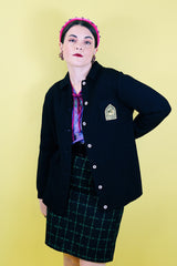 Women's vintage 1960's Dorce label long sleeve black wool button up cardigan with yellow patch with words La Costa on left chest.