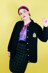 Women's vintage 1960's Dorce label long sleeve black wool button up cardigan with yellow patch with words La Costa on left chest.