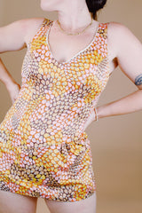 sleeveless one piece bathing suit in pink orange and yellow paisley print with skirt over bottom vintage 1970's