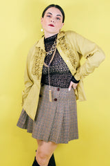 Women's vintage and retro 1990's Limited, Made in Italy label mini skirt in brown plaid print with a wrap front closure and four brown buttons.