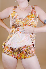 sleeveless one piece bathing suit in pink orange and yellow paisley print with skirt over bottom vintage 1970's