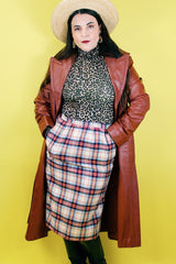 Women's vintage 1970's Weathervane label knee length pencil skirt in wool material, fully lined, cream color with red, navy, and blue plaid print.