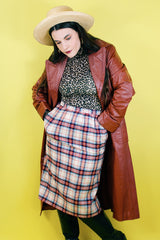 Women's vintage 1970's Weathervane label knee length pencil skirt in wool material, fully lined, cream color with red, navy, and blue plaid print.