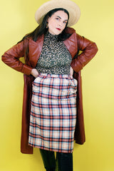 Women's vintage 1970's Weathervane label knee length pencil skirt in wool material, fully lined, cream color with red, navy, and blue plaid print.