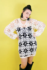 Women's vintage 1970's long sleeve white cream crochet dress with balloon sleeves and a V shaped neckline.