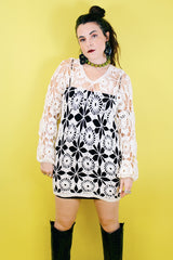 Women's vintage 1970's long sleeve white cream crochet dress with balloon sleeves and a V shaped neckline.