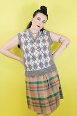 Women's or men's vintage 1970's Churchill Downs, Made in England label sleeveless sweater vest in grey wool with light pink and light blue argyle print on the front.