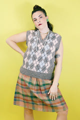 Women's or men's vintage 1970's Churchill Downs, Made in England label sleeveless sweater vest in grey wool with light pink and light blue argyle print on the front.