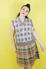 Women's or men's vintage 1970's Churchill Downs, Made in England label sleeveless sweater vest in grey wool with light pink and light blue argyle print on the front.