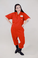 short sleeve red work jumpsuit with collar zips up front and patches on front and back vintage 1970's