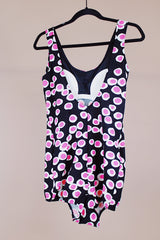 vintage 1960's one piece swimsuit in black with white and pink polka dots skirt in front over bottoms