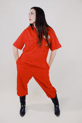 short sleeve red work jumpsuit with collar zips up front and patches on front and back vintage 1970's