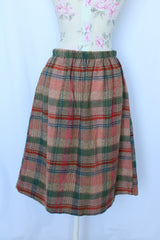 Women's vintage 1970's Pretty Plus label plaid print knee length pencil skirt with elastic waistband in a wool blend material.