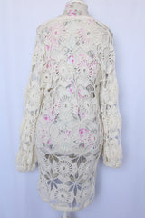 Women's vintage 1970's long sleeve white cream crochet dress with balloon sleeves and a V shaped neckline.