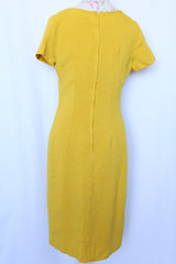 Women's vintage 1960's Jan Sue label short sleeve knee length shift dress in yellow cotton with multicolored floral print stitched on the front.