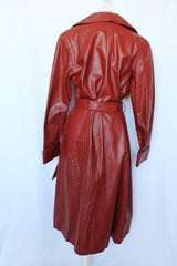 Women's vintage 1970's long length long sleeve leather wrap coat in maroon color. Double lapel, tie belt, pockets.