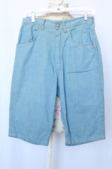 Women's vintage 1980's Rocking Brand label knee length light blue denim bermuda shorts with zipper and button closure in the front.