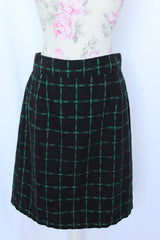 Women's vintage 1970's Made in USA label black knee length pencil skirt with bright green checkered plaid print in a wool and polyester blend material.