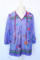 Women's vintage 1970's That's It! California label 3/4 arm length purple sheer lightweight polyester material pullover blouse in purple with all over floral print.