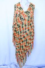 Women's vintage 1970's acrylic knit multicolored poncho with a long fringe trim hem, drawstring at neck, and V shaped neckline in orange, mustard yellow, and olive green colors.