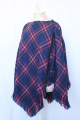 Women's vintage 1970's one size fits most navy and purple plaid print poncho with fringe hem trim and button closure on shoulder in acrylic material.