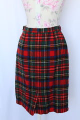 Women's vintage 1970's knee length pencil skirt in an acrylic material in red, blue, yellow, and white all over tartan plaid print.