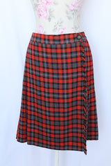 Women's vintage retro 1990's mini length plaid print wrap skirt in red, grey, black, and yellow. Acrylic material. Fringe edge, elastic waistband.