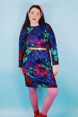 Women's vintage 1980's Blair, Warren, PA label long sleeve mini length polyester material dress in blue, pink, red, and green all over floral print. Dolman fit with elastic waistband.