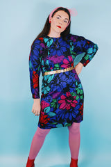 Women's vintage 1980's Blair, Warren, PA label long sleeve mini length polyester material dress in blue, pink, red, and green all over floral print. Dolman fit with elastic waistband.