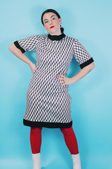 Women's vintage 1970's Mode O'Day, Styled in California label short sleeve mini length dress in black and white polyester material with diamond checkered print.