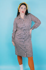 Women's vintage 1970's long sleeve knee length button up shirt dress in brown with all over white floral print.
