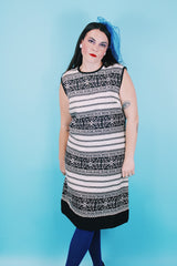 Women's vintage 1960's sleeveless knee length shirt dress in a linen material in black and white colors.