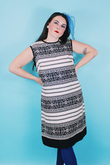 Women's vintage 1960's sleeveless knee length shirt dress in a linen material in black and white colors.