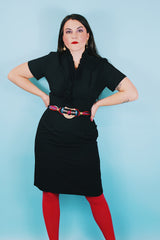 Women's vintage 1960's A Topaz Original label short sleeve knee length black polyester shift dress with a ruffle trim v shaped neckline.