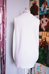 sleeveless white sweater vest with v neck with crest on left chest vintage 1970's