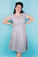 Women's vintage 1950's capped sleeved midi length lace fancy dress. Fully lined in lilac polyester with baby blue lace overlay.