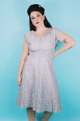 Women's vintage 1950's capped sleeved midi length lace fancy dress. Fully lined in lilac polyester with baby blue lace overlay.