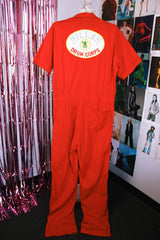 short sleeve red work jumpsuit with collar zips up front and patches on front and back vintage 1970's