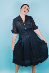 Women's vintage 1950's short sleeve midi length navy blue sheer shirt dress with subtle checkered print.