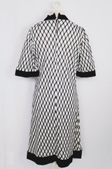 Women's vintage 1970's Mode O'Day, Styled in California label short sleeve mini length dress in black and white polyester material with diamond checkered print.