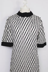 Women's vintage 1970's Mode O'Day, Styled in California label short sleeve mini length dress in black and white polyester material with diamond checkered print.