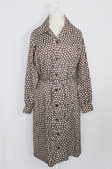 Women's vintage 1970's long sleeve knee length button up shirt dress in brown with all over white floral print.