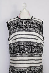 Women's vintage 1960's sleeveless knee length shirt dress in a linen material in black and white colors.