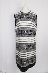 Women's vintage 1960's sleeveless knee length shirt dress in a linen material in black and white colors.