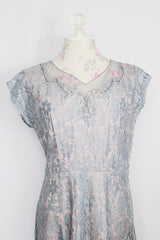 Women's vintage 1950's capped sleeved midi length lace fancy dress. Fully lined in lilac polyester with baby blue lace overlay.