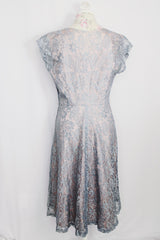 Women's vintage 1950's capped sleeved midi length lace fancy dress. Fully lined in lilac polyester with baby blue lace overlay.