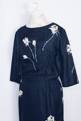 Women's vintage 1950's Original Nai Tuman Petites New York 3/4 arm length midi length navy blue dress with cream colored floral print in silk material.