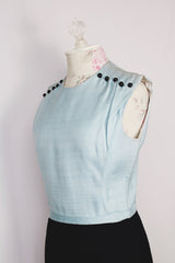 Women's vintage 1960's Richard Frontman label sleeveless twofer knee length sheath dress in cotton blend material. Top half is baby blue and bottom half is black.