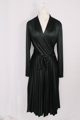 Women's vintage 1970's Joan Curtis long sleeve midi length black dress with pleated accordion skirt, a V shaped neckline, and detachable matching tie belt.