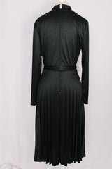 Women's vintage 1970's Joan Curtis long sleeve midi length black dress with pleated accordion skirt, a V shaped neckline, and detachable matching tie belt.